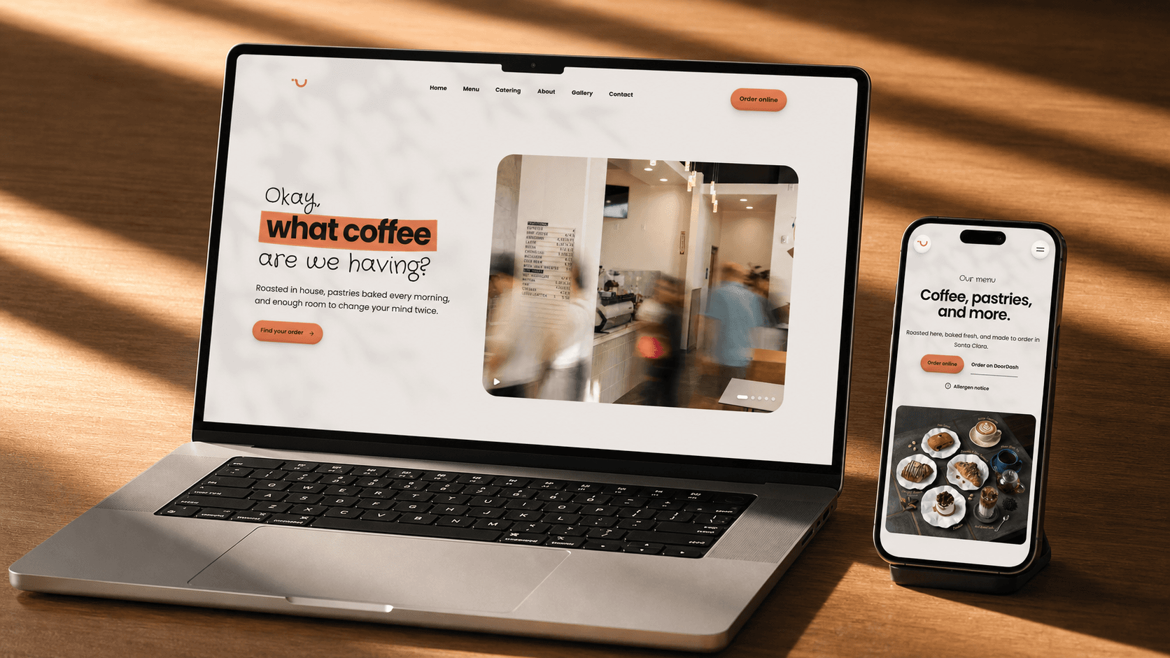 WhatCoffee website displayed on a laptop and phone on a sunlit wooden desk